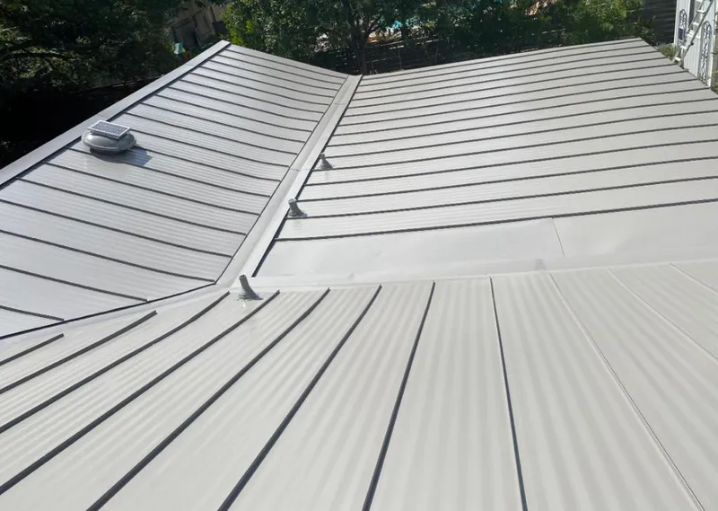 Solar attic fan installed on a metal roof for Roof Ventilation in Clinton